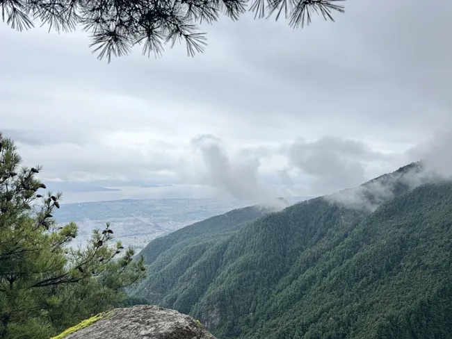 Clouds drifting across the mountainside.
