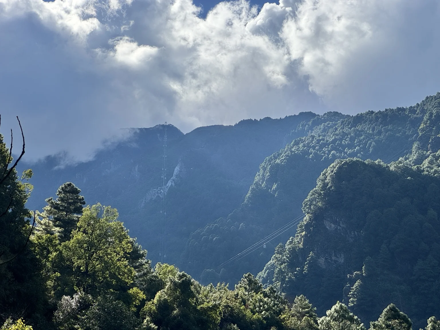 Sunlight breaking through clouds above Cangshan.
