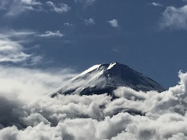 Mount Fuji emerges above the clouds.