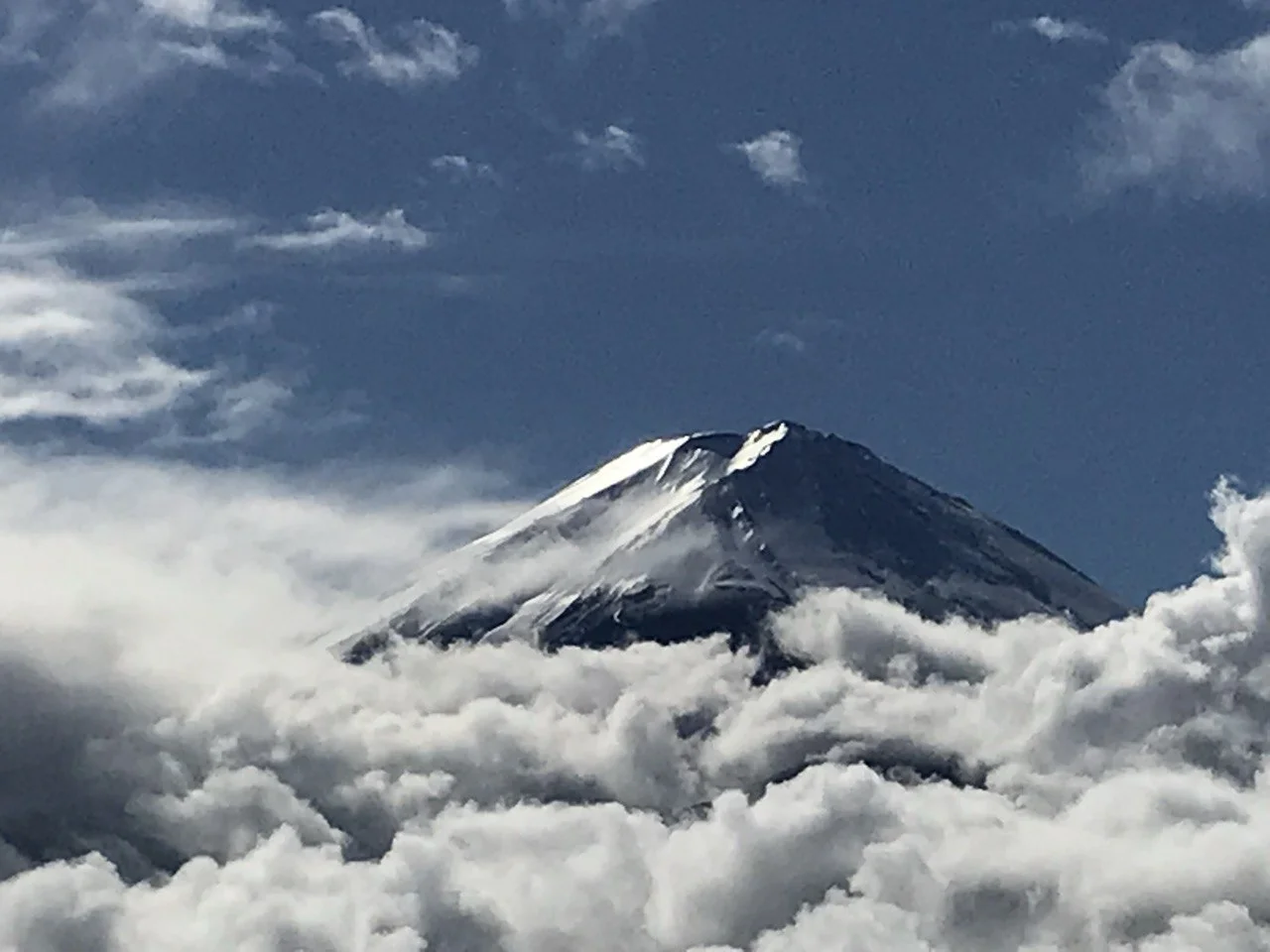 Mount Fuji emerges above the clouds.