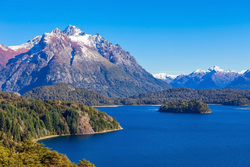 Sunlit Patagonian mountains and a blue alpine lake