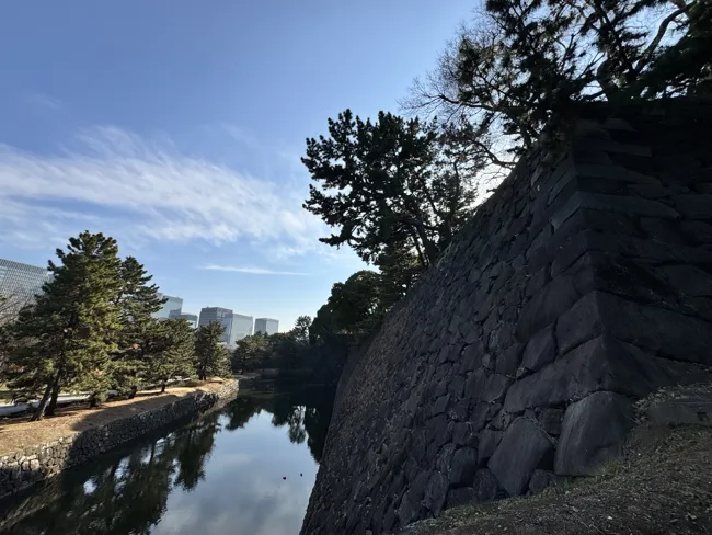 Following the palace walls and the water.