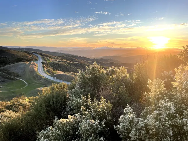 Evening light, with the Pacific beyond the hills.